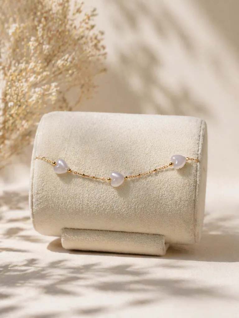 Delicate gold bracelet on soft display.webp