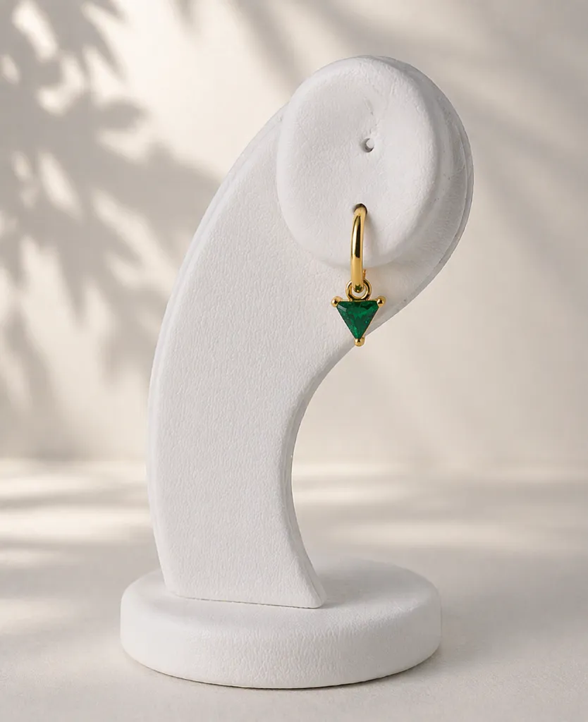 Elegant jewelry display with gold earring.webp